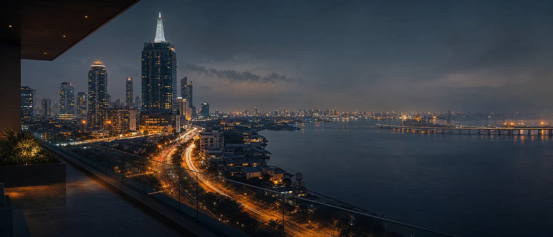 Cinematic elevated view across the Lagos waterfront, commercial skyline and illuminated transport corridors at blue hour.